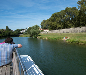 12 (1) a person sitting on a bench next to a body of water