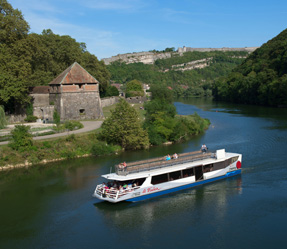 13 (1) a boat traveling along a river next to a body of water