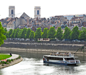 17 (1) a small boat in a body of water with a city in the background
