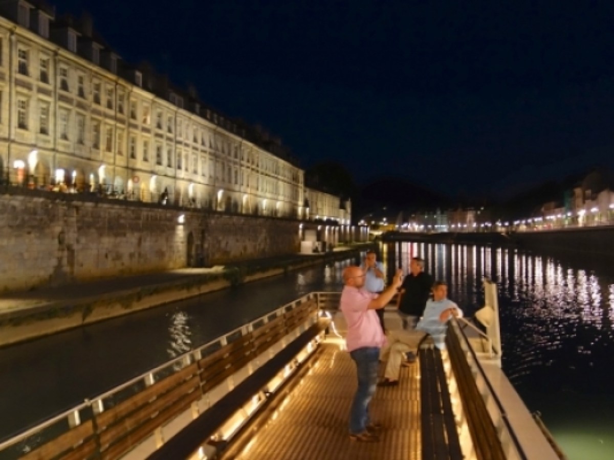 a person walking across a bridge over water
