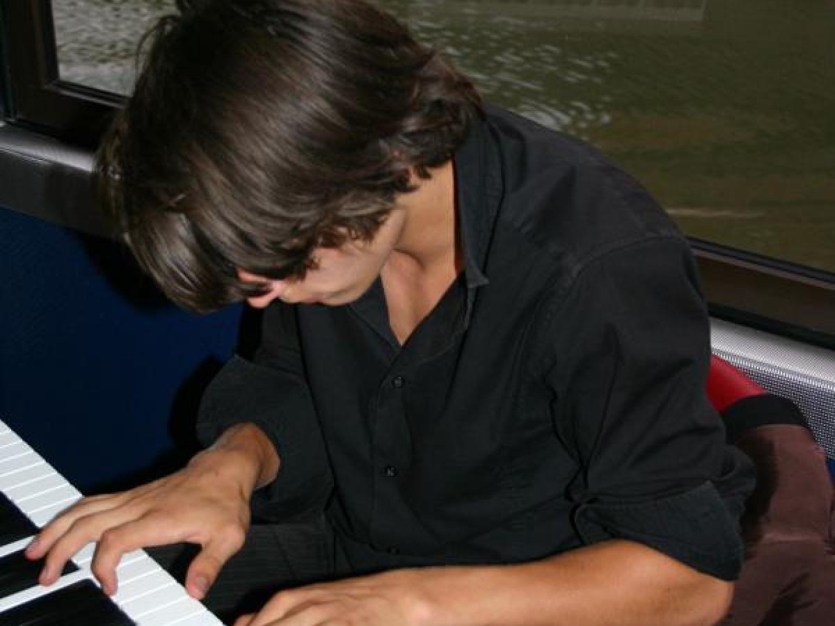 a person sitting in front of a piano