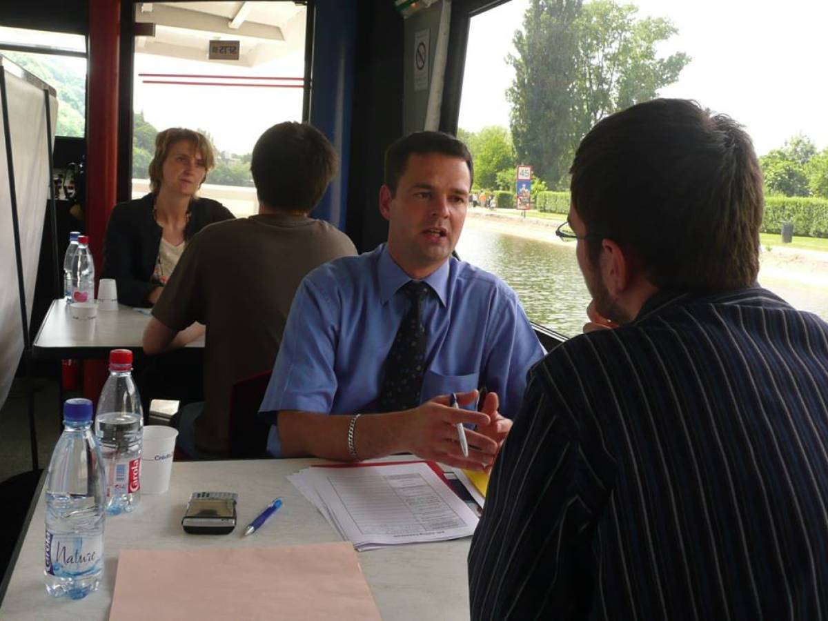 a group of people sitting at a table in front of a window