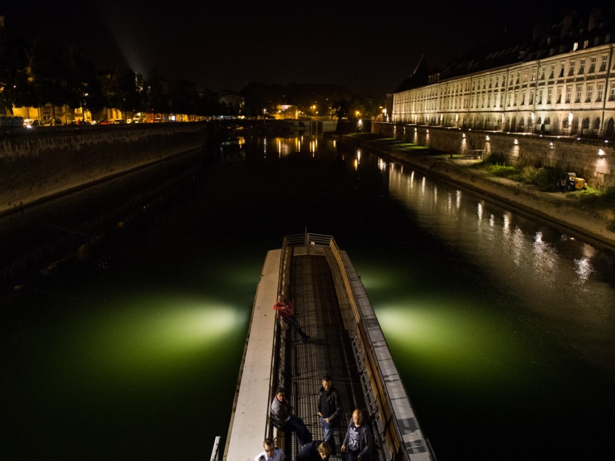 a train crossing a bridge over a body of water