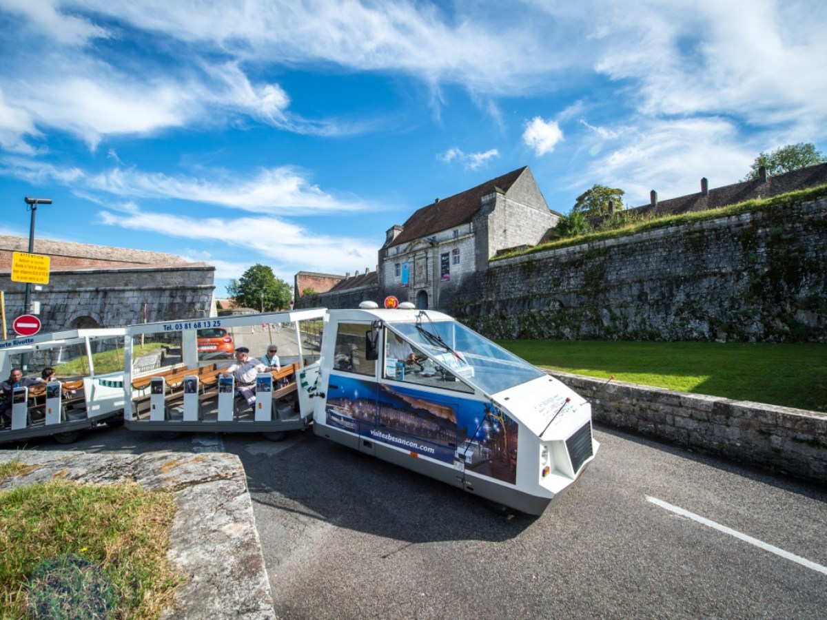 a passenger bus that is parked on the side of a road