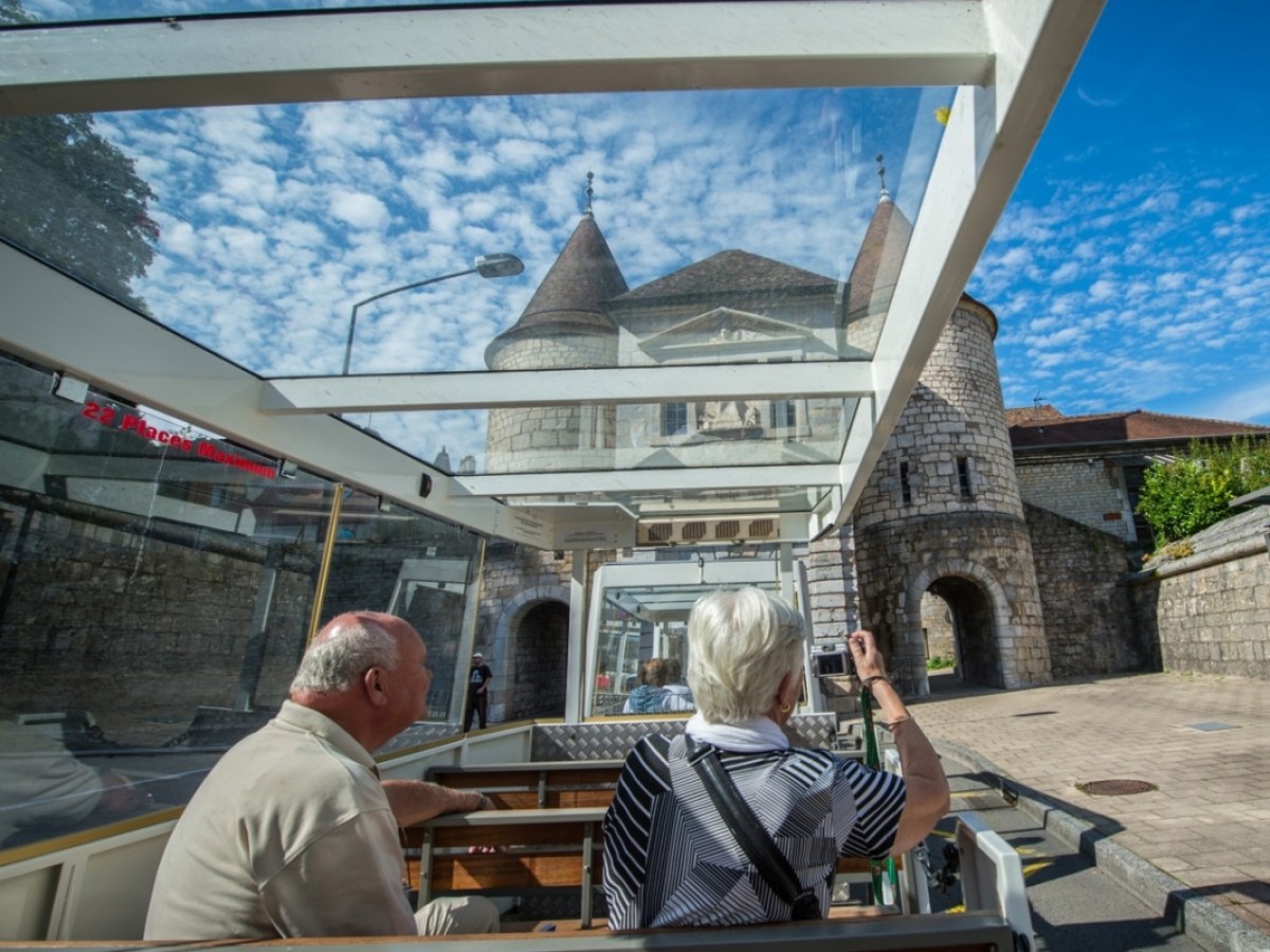 a group of people sitting in front of a building