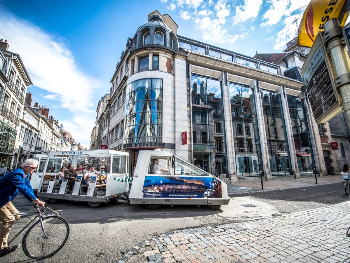 a person riding a bicycle on a city street
