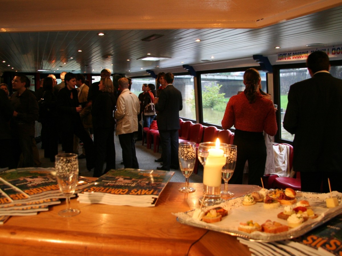 a group of people sitting at a table eating pizza