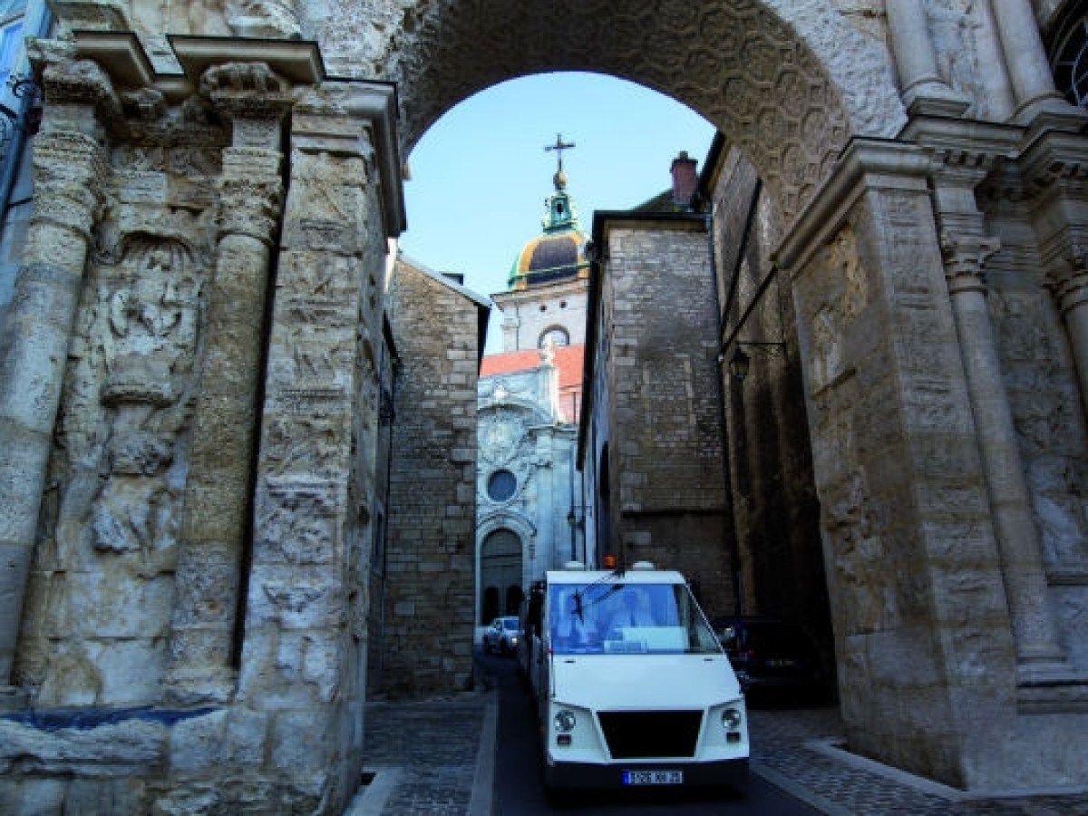 a close up of a stone building that has a sign on the street