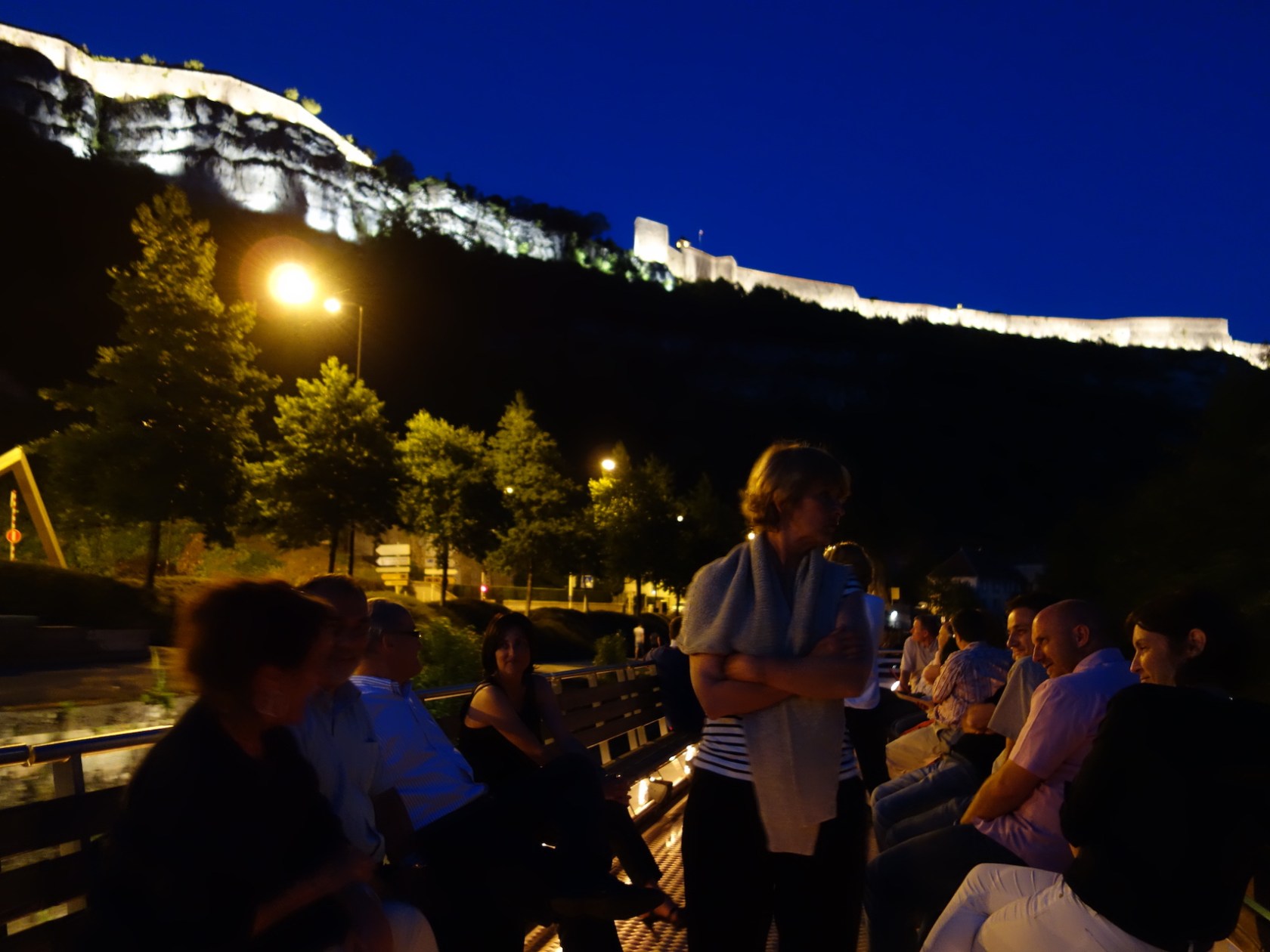 a group of people standing in front of a mountain