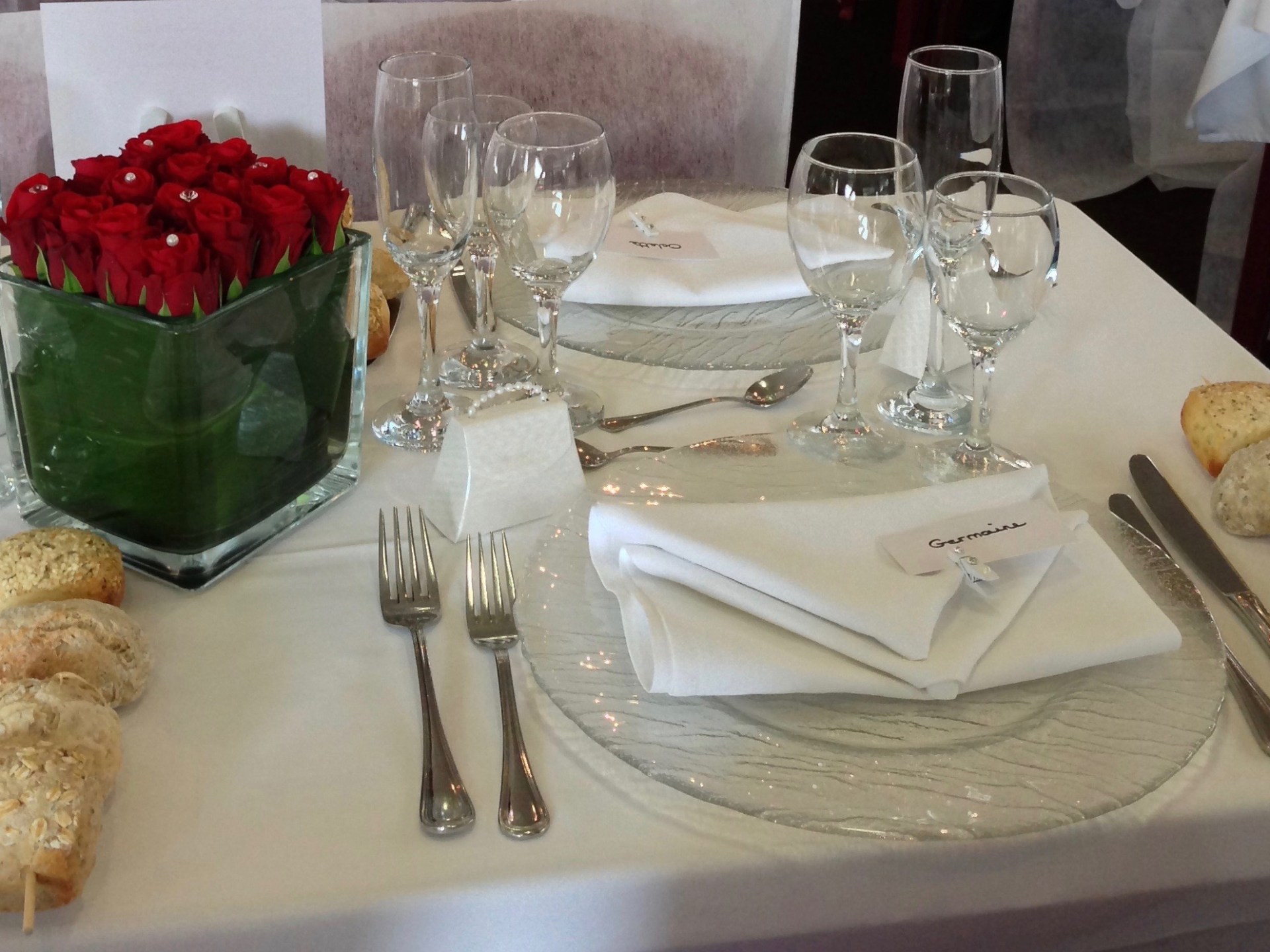 a plate of food and glasses of wine on a table